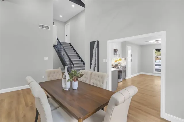 a view of a dining room with furniture and wooden floor