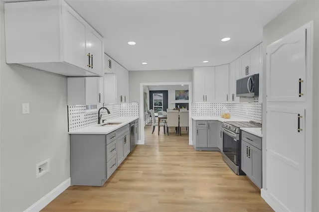 a large kitchen with stainless steel appliances lots of counter top space