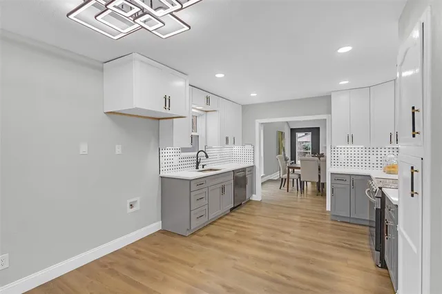 a kitchen with furniture a counter space a sink appliances and cabinets