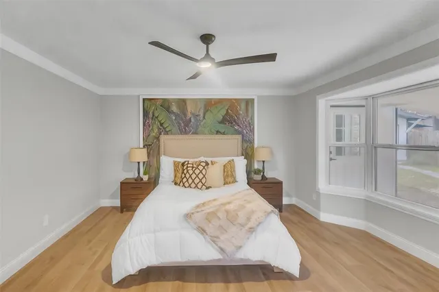 a bedroom with a large bed and a chandelier