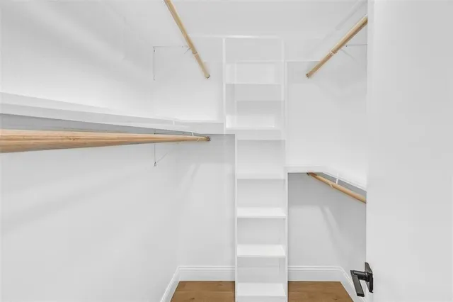 a view of walk in closet with empty racks