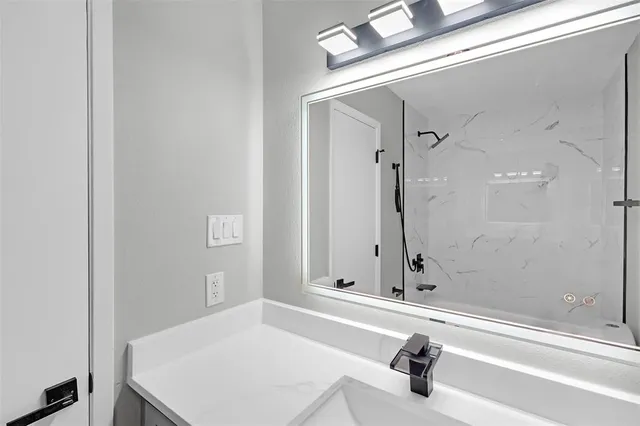 a bathroom with a tub and a sink
