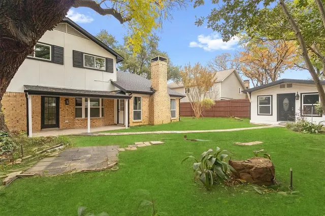 a front view of a house with a garden and yard