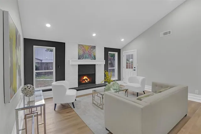 a living room with furniture and a fireplace