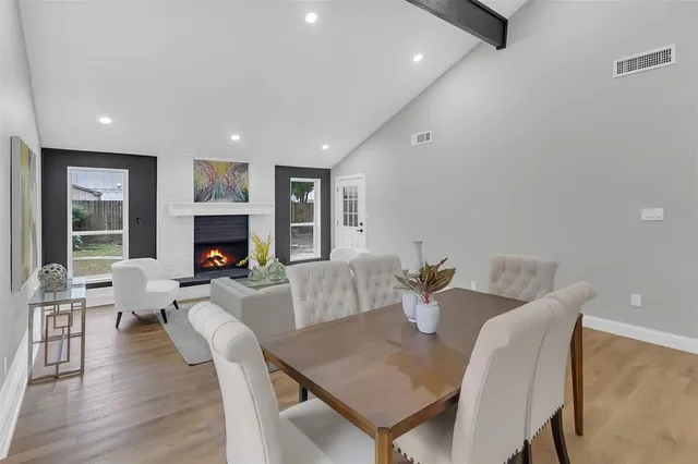 a living room with furniture a fireplace and a table