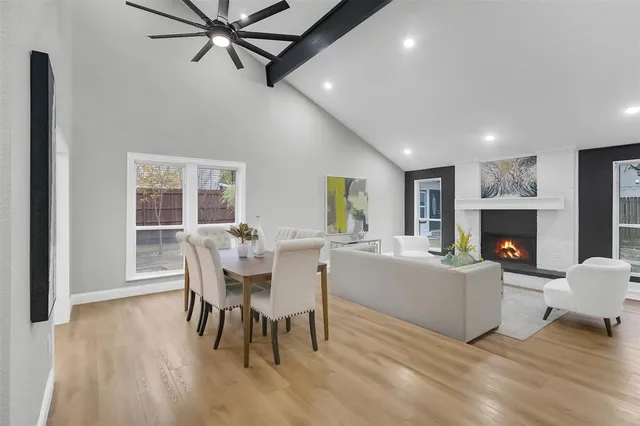 a living room with furniture a fireplace and a table