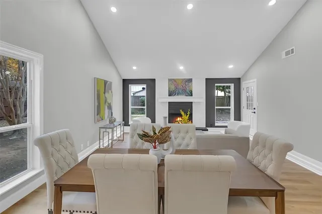a living room with fireplace furniture and a large window