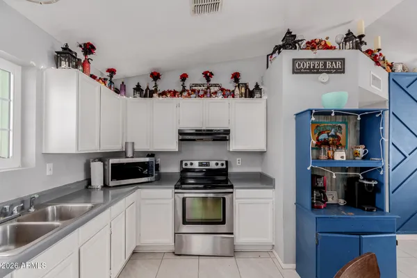 a kitchen with a refrigerator and a sink