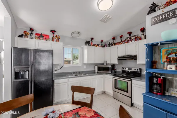 a kitchen with stainless steel appliances granite countertop a refrigerator and a stove top oven