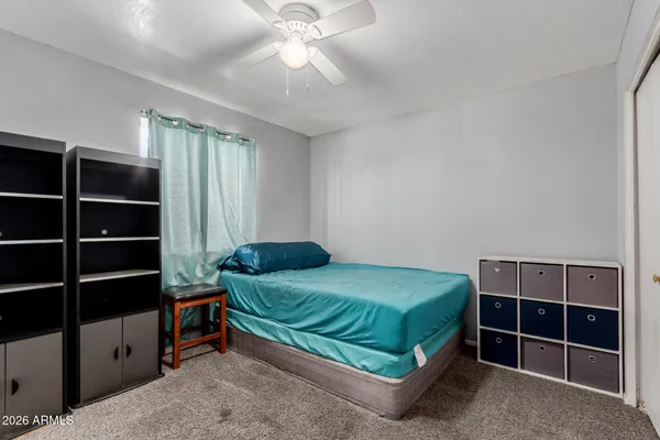 a bedroom with a bed and a closet