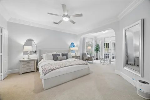 a bedroom with bed and a chandelier