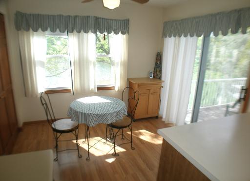 -n212 Windermere Road, Unit 2808 Winfield, IL 60190 - Photo 4 of 9 a view of a dining room with furniture window and wooden floor