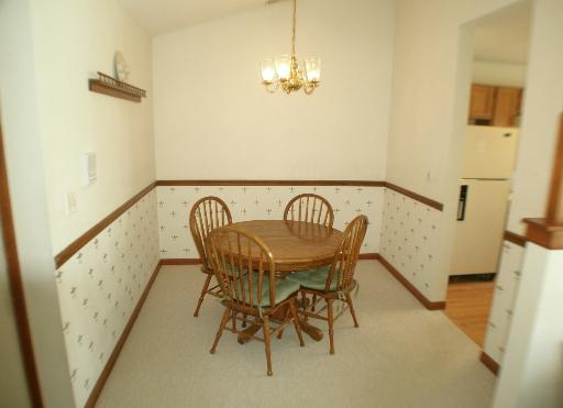 -n212 Windermere Road, Unit 2808 Winfield, IL 60190 - Photo 6 of 9 a view of a dining room with furniture and a chandelier