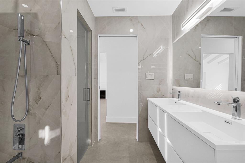 2291 Southwest 17th Street Miami, FL 33145 - Photo 33 of 86 a bathroom with a double vanity sink a mirror and a shower