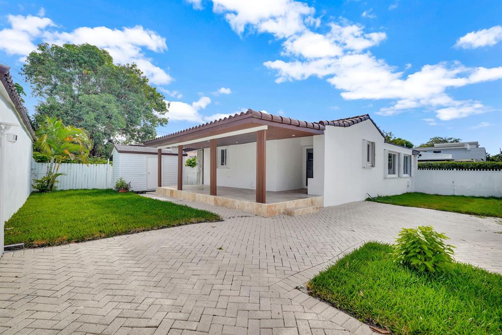 2291 Southwest 17th Street Miami, FL 33145 - Photo 10 of 86 a view of a white house with a yard and large tree