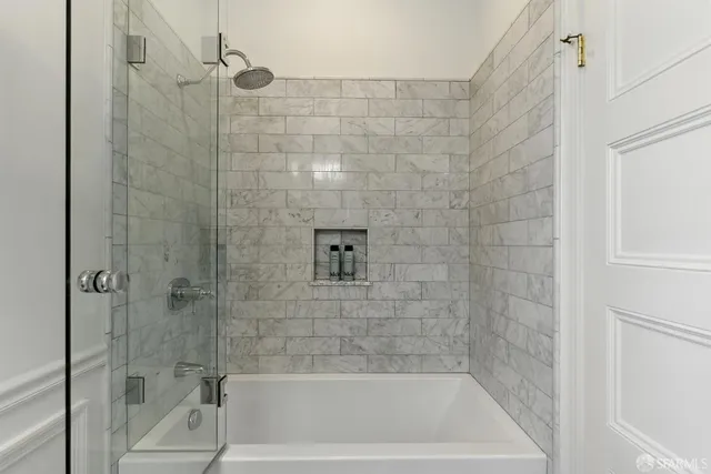 a bath tub sitting next to a shower
