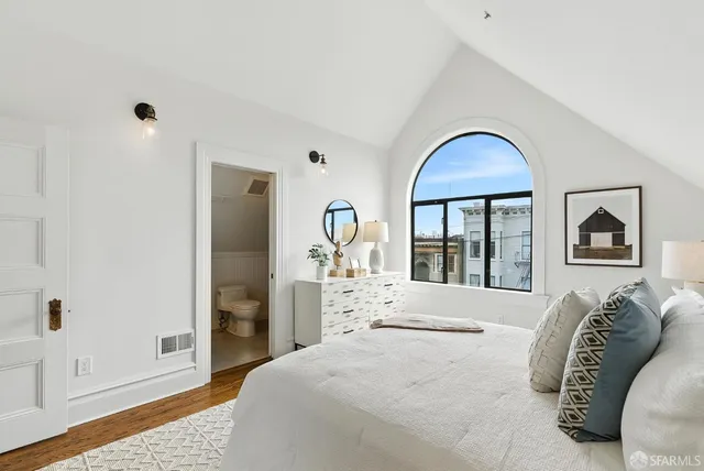 a bedroom with a bed and a large window