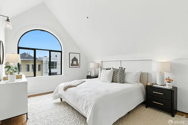 a bedroom with a large bed and a large window