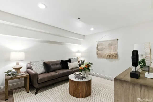 a living room with furniture and a potted plant
