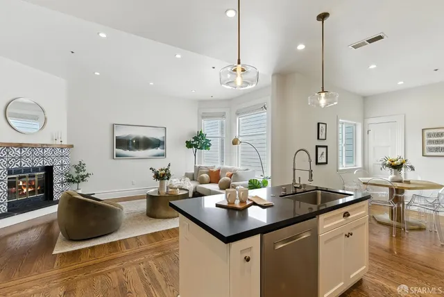 a kitchen with a counter space a sink appliances and cabinets