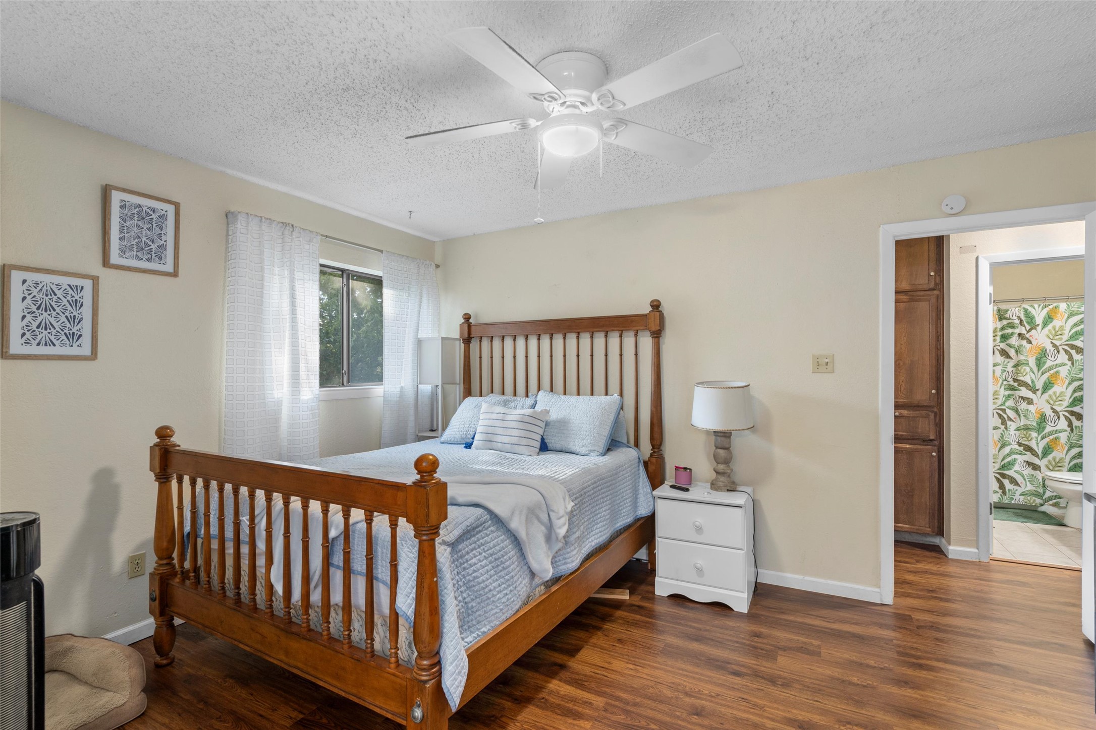 6492 Hart Lane Austin, TX 78731 - Photo 15 of 22 Bedroom with dark wood-type flooring, a ceiling fan, and a textured ceiling