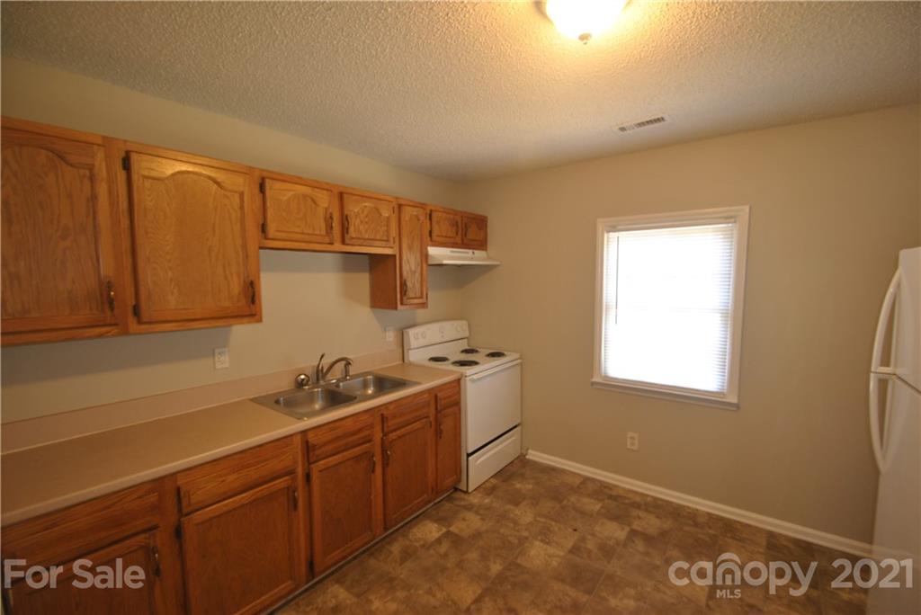 2812 Mayflower Road Charlotte, NC 28208 - Photo 5 of 7 a kitchen with sink cabinets and window