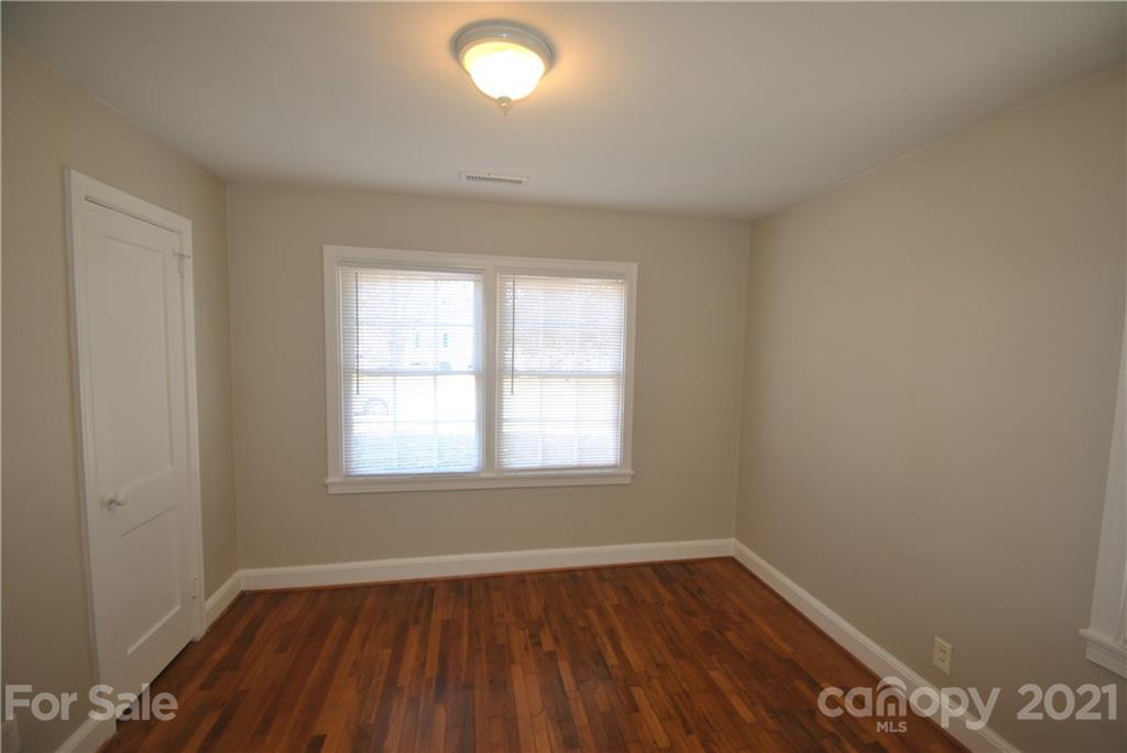 2812 Mayflower Road Charlotte, NC 28208 - Photo 6 of 7 an empty room with wooden floor and windows