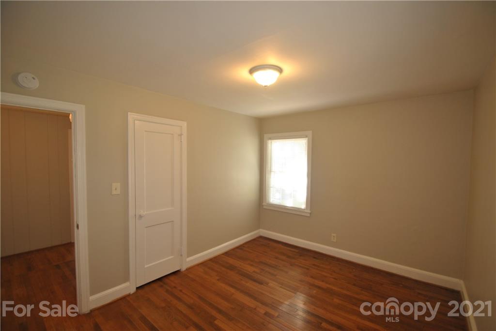 2812 Mayflower Road Charlotte, NC 28208 - Photo 7 of 7 an empty room with wooden floor and windows