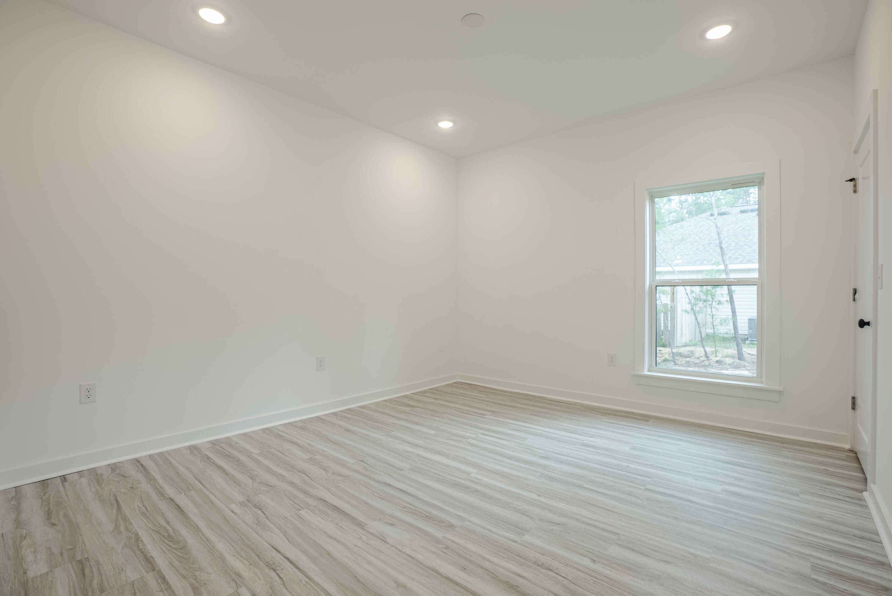 2351 Dumajack Road Chipley, FL 32428 - Photo 17 of 31 an empty room with wooden floor and windows