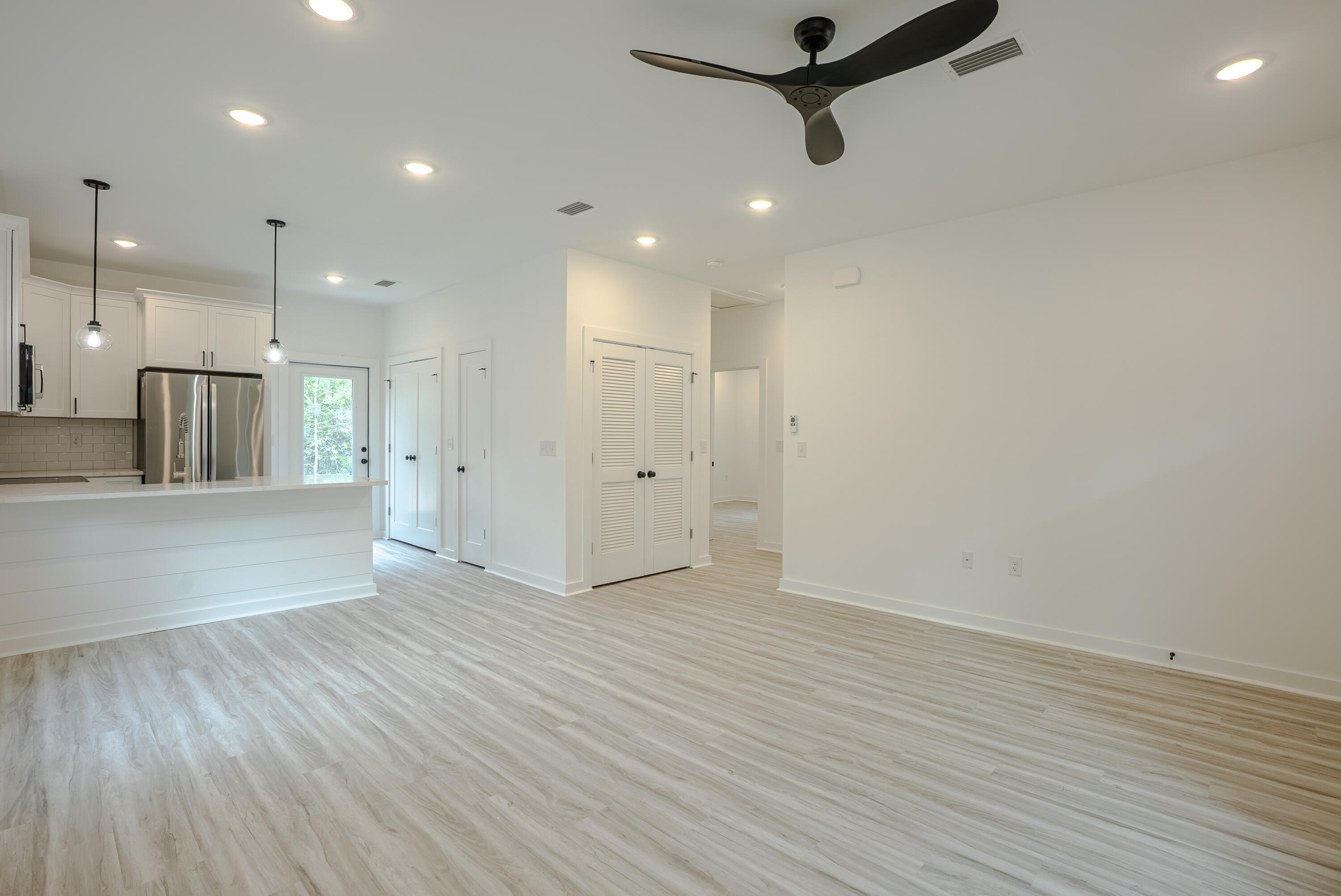 2351 Dumajack Road Chipley, FL 32428 - Photo 4 of 31 a view of an empty room and kitchen with wooden floor