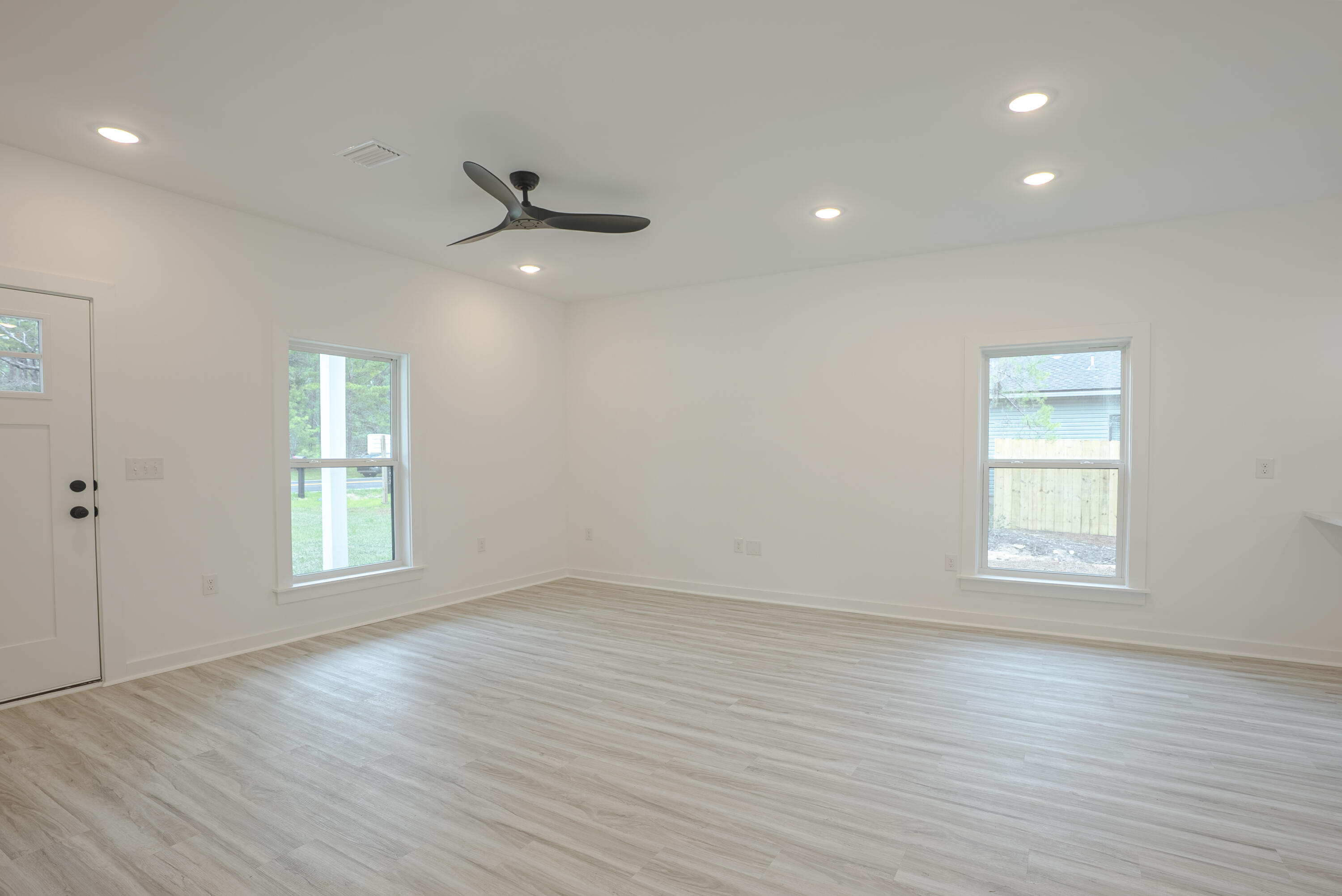 2351 Dumajack Road Chipley, FL 32428 - Photo 5 of 31 an empty room with wooden floor and windows