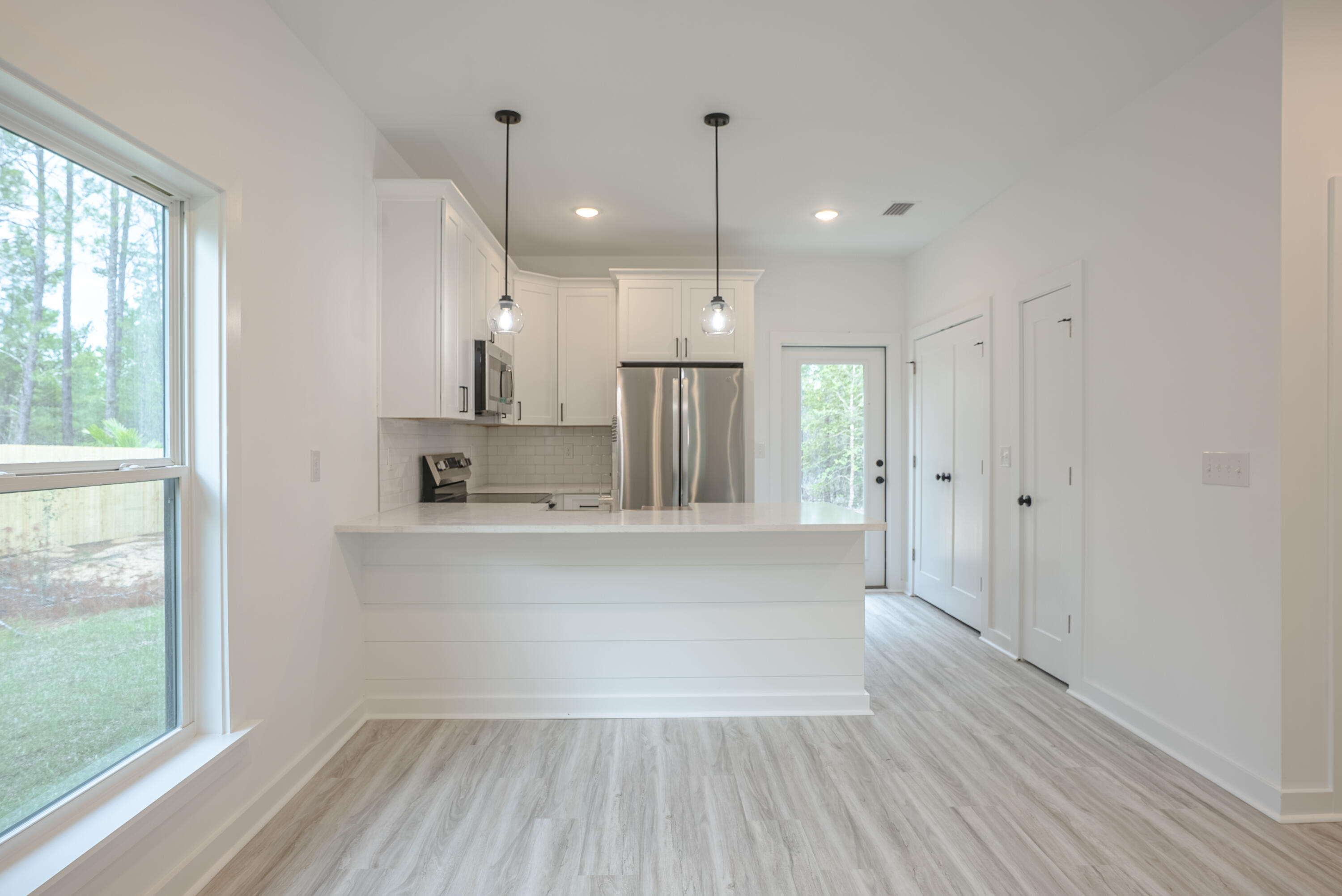 2351 Dumajack Road Chipley, FL 32428 - Photo 7 of 31 a large kitchen with hardwood floor and a large window