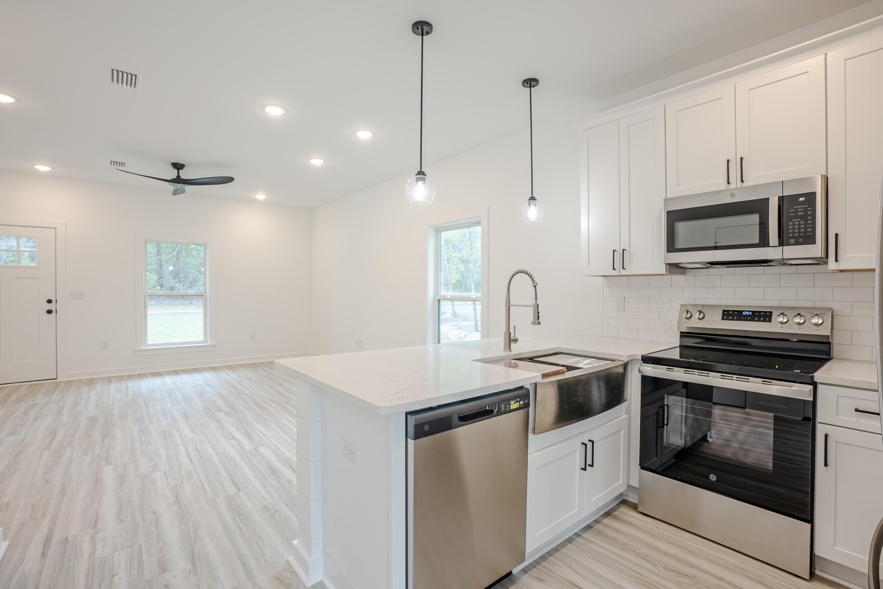 2351 Dumajack Road Chipley, FL 32428 - Photo 10 of 31 a kitchen with stainless steel appliances granite countertop a stove a sink and a microwave