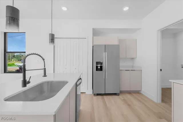 a kitchen with a sink and a refrigerator