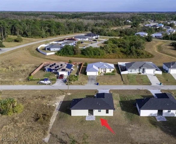 an aerial view of a houses with a yard