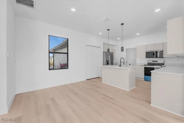 a view of a kitchen with microwave and cabinets