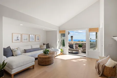 a view of a balcony with wooden floor and iron fence