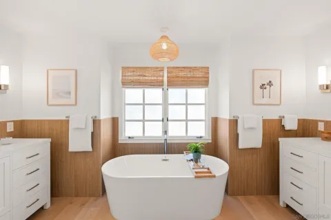 a spacious bathroom with a tub shower and mirror