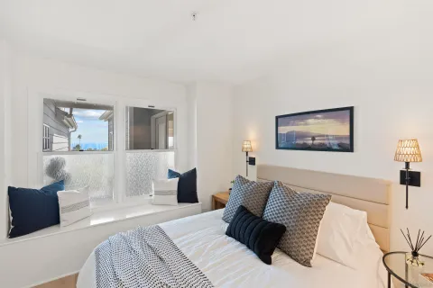 a bathroom with a granite countertop sink a toilet and a mirror