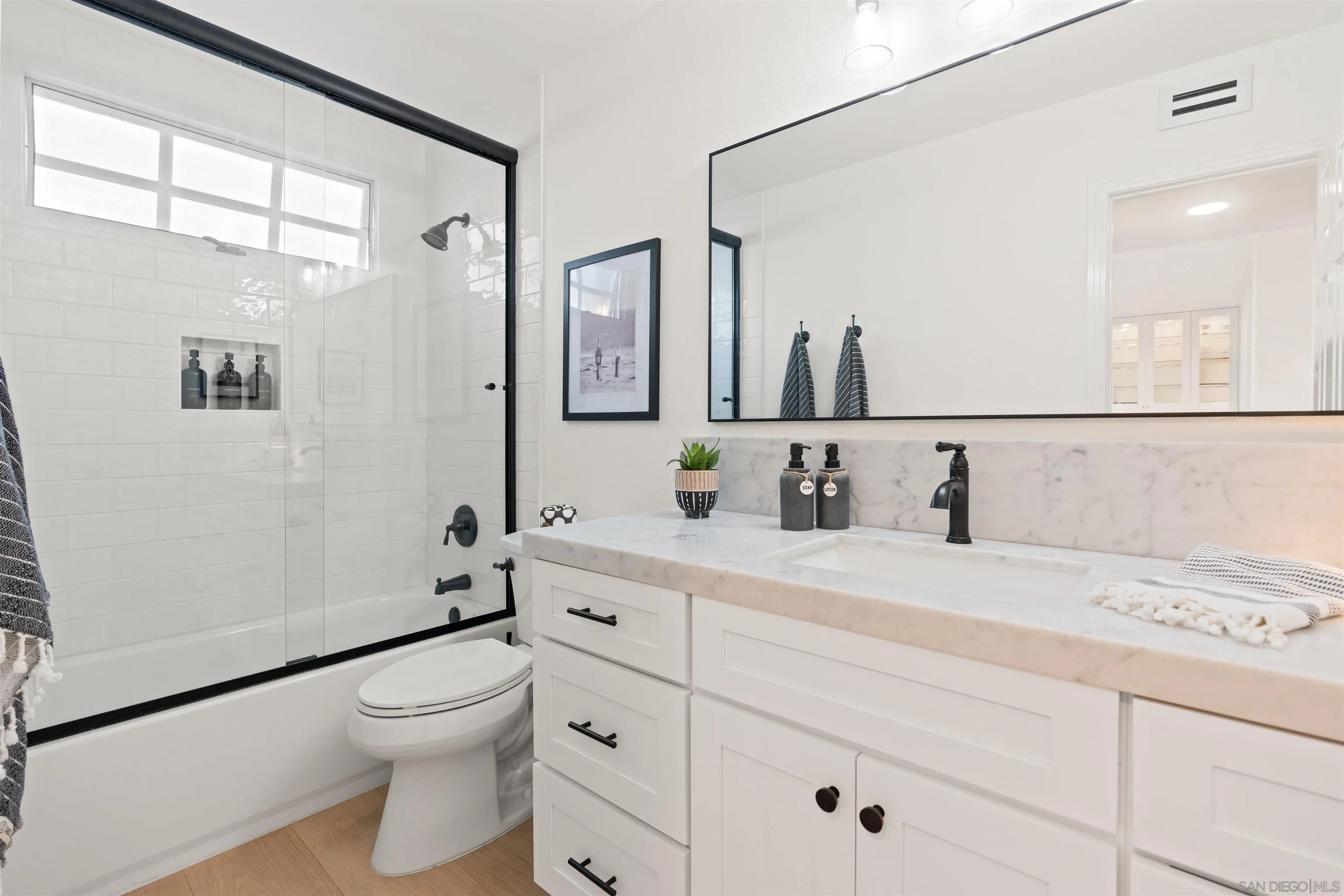 33671 Granada Drive, Unit 5 Dana Point, CA 92629 - Photo 16 of 25 a bathroom with a granite countertop sink a toilet and a mirror