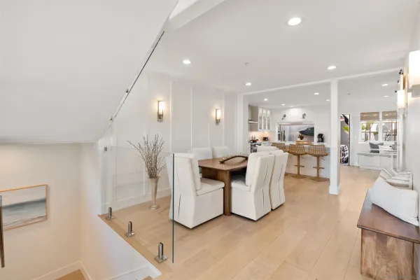 a kitchen with a stove a kitchen island a stove a sink a dining table and chairs