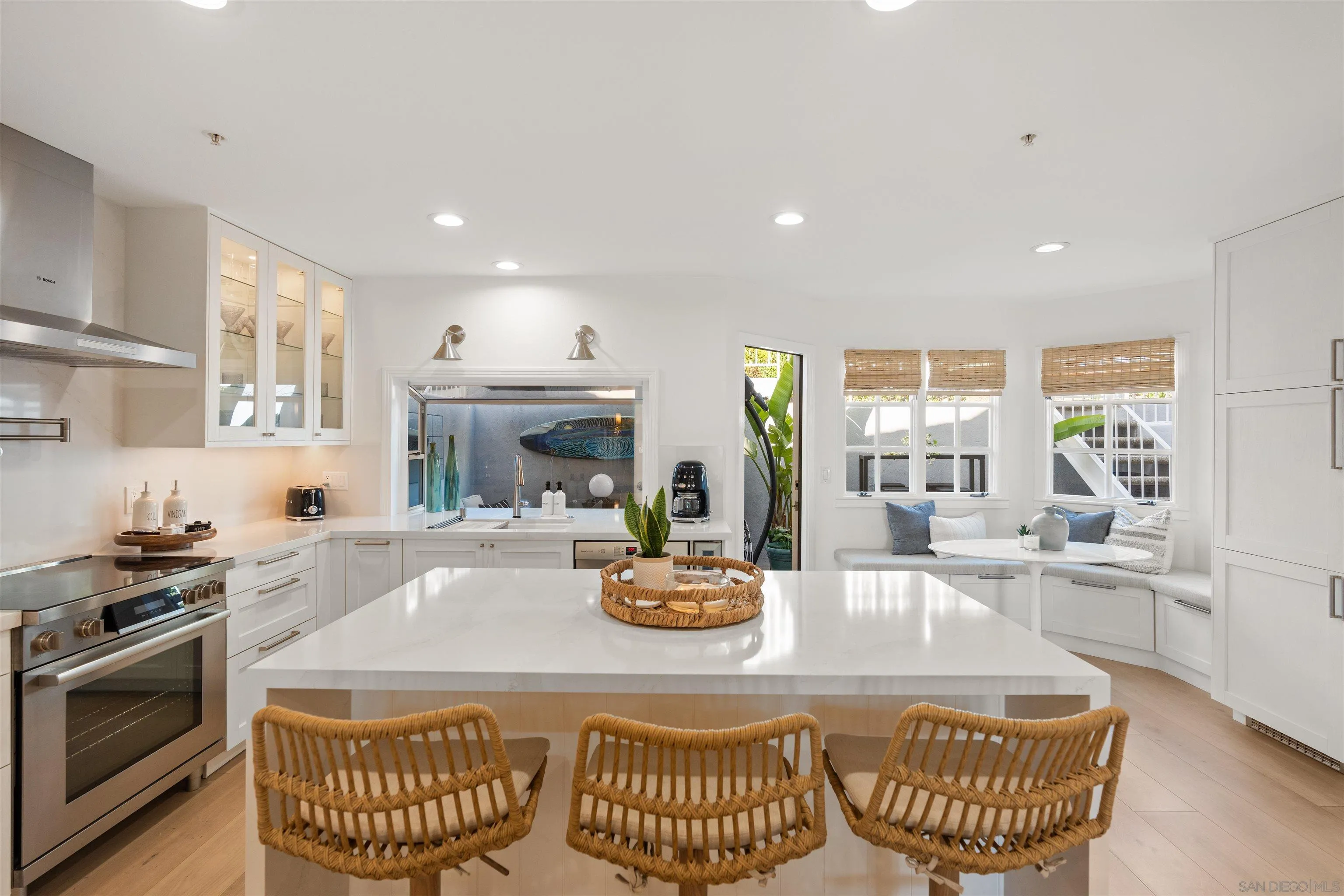 33671 Granada Drive, Unit 5 Dana Point, CA 92629 - Photo 8 of 25 a kitchen with a stove a kitchen island a stove a sink a dining table and chairs