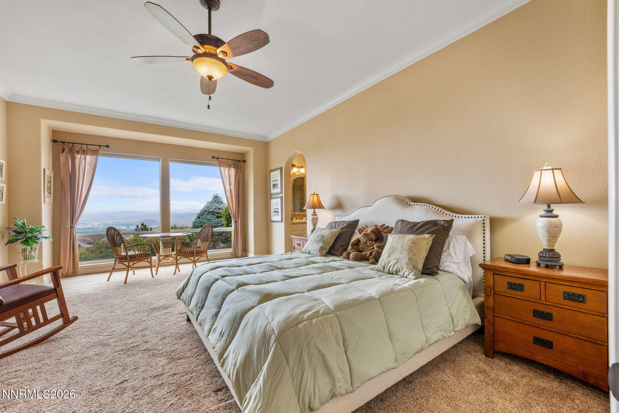 10170 Vía Como Reno, NV 89511 - Photo 19 of 85 a bedroom with a bed a large window and a chandelier