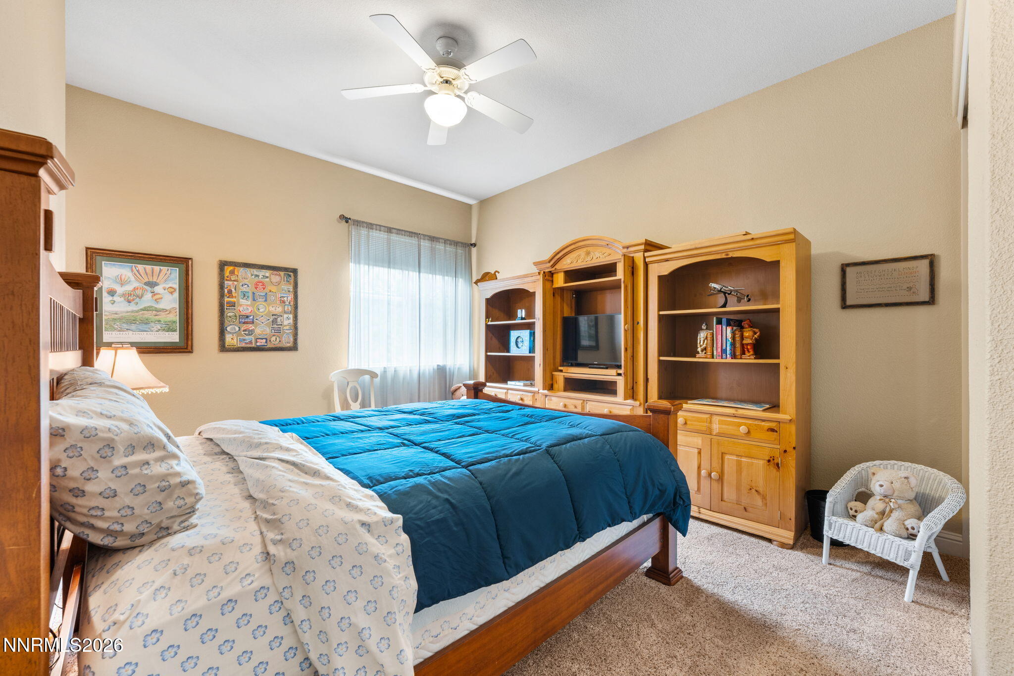 10170 Vía Como Reno, NV 89511 - Photo 30 of 85 a bedroom with a bed and a chandelier