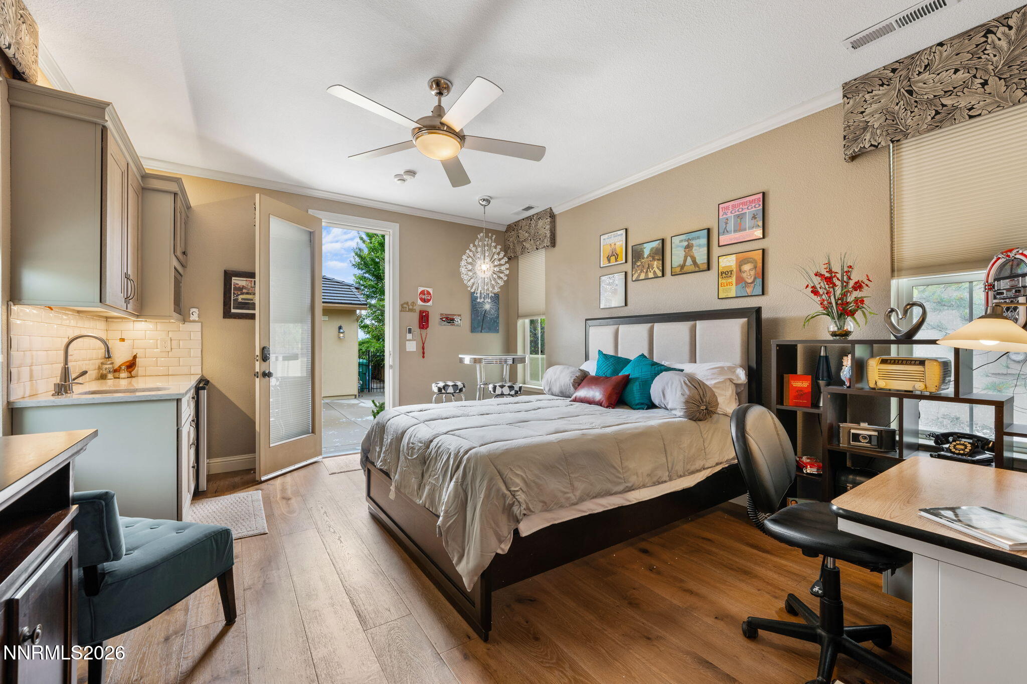 10170 Vía Como Reno, NV 89511 - Photo 34 of 85 a bedroom with a bed a desk and chair with the wooden floor