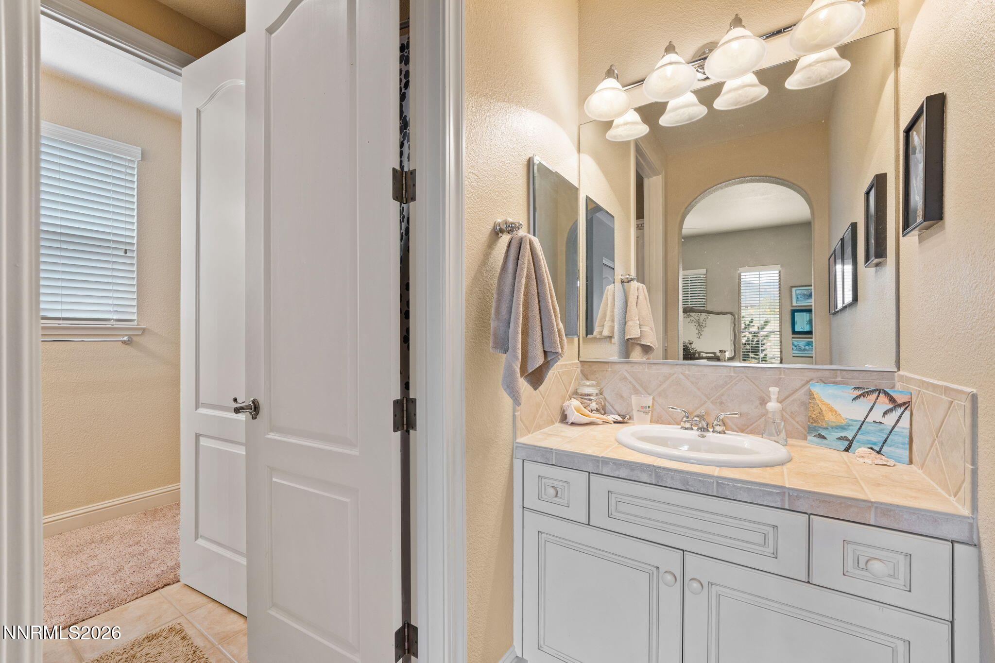 10170 Vía Como Reno, NV 89511 - Photo 35 of 85 a bathroom with a sink vanity and a mirror