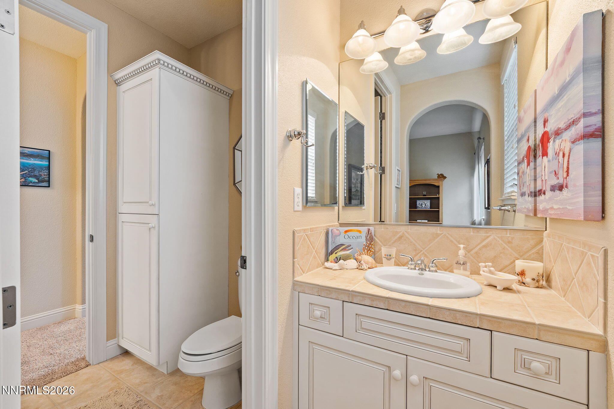 10170 Vía Como Reno, NV 89511 - Photo 37 of 85 a bathroom with a sink a toilet and a mirror