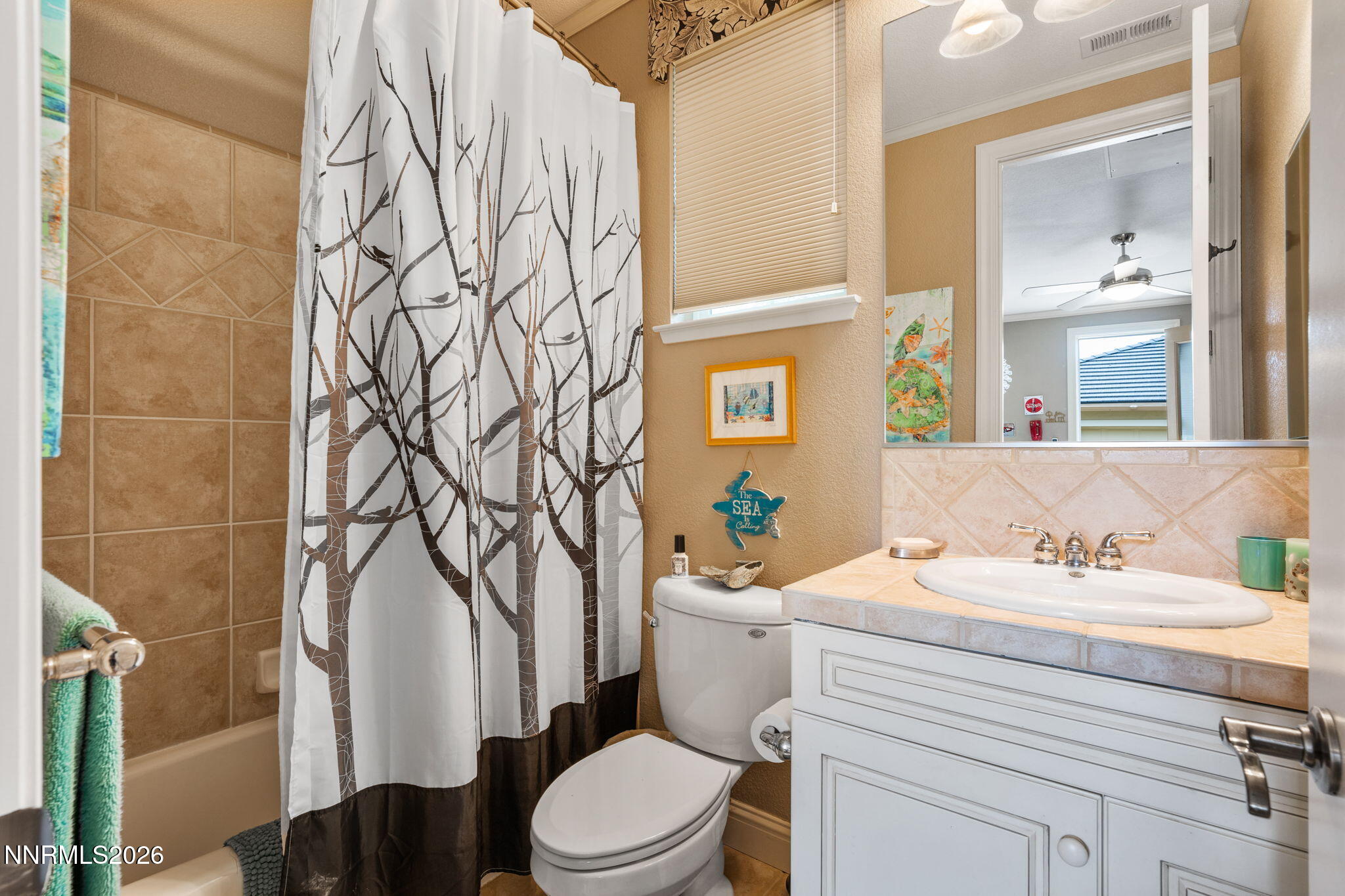 10170 Vía Como Reno, NV 89511 - Photo 39 of 85 a bathroom with a sink a toilet and a mirror