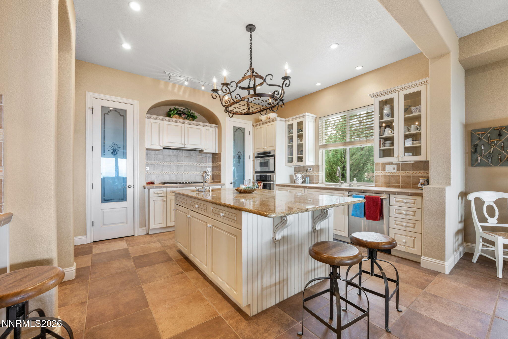 10170 Vía Como Reno, NV 89511 - Photo 4 of 85 a open kitchen with stainless steel appliances granite countertop a stove a sink a refrigerator and a dining table