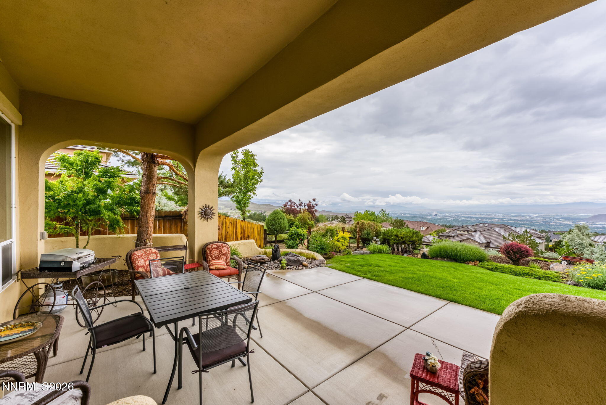 10170 Vía Como Reno, NV 89511 - Photo 42 of 85 a view of a patio with lawn chairs floor to ceiling window and lake view